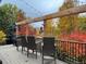 Gorgeous covered back deck with seating and fall foliage views is the perfect place for entertaining or a quiet evening at 20460 Oakbrook Ln, Parker, CO 80138