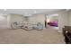 Finished basement featuring a large sectional sofa and an open doorway to a bedroom at 20460 Oakbrook Ln, Parker, CO 80138
