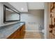 Bathroom featuring granite countertops, wood cabinets, a large mirror and tile floors at 20460 Oakbrook Ln, Parker, CO 80138