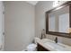Well-lit half bathroom featuring a vanity with granite countertop and decorative mirror at 20460 Oakbrook Ln, Parker, CO 80138