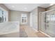 Inviting bathroom featuring tiled floors, a soaking tub, and a glass-enclosed shower at 20460 Oakbrook Ln, Parker, CO 80138
