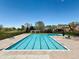 Large community pool with lane dividers, lounge chairs, and picnic tables for residents to enjoy at 20460 Oakbrook Ln, Parker, CO 80138