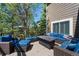 Outdoor deck features comfortable wicker seating with blue cushions and a metal outdoor fire pit at 20460 Oakbrook Ln, Parker, CO 80138