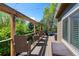 Relaxing deck with wicker seating and a pergola overlooking a lush, green treeline at 20460 Oakbrook Ln, Parker, CO 80138