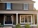 Up close, this inviting house with a front porch welcomes you with a stylish front door with glass panels at 20460 Oakbrook Ln, Parker, CO 80138