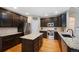 This expansive kitchen showcases granite countertops, stainless steel appliances, and dark wood cabinetry at 20460 Oakbrook Ln, Parker, CO 80138