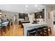 Well-lit kitchen boasts granite countertops, dark cabinetry, stainless steel appliances, and hardwood flooring at 20460 Oakbrook Ln, Parker, CO 80138