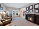 Inviting living room featuring a fireplace, large window with shutters, and comfortable seating at 20460 Oakbrook Ln, Parker, CO 80138