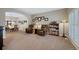 Cozy living room with plush armchairs, carpeted floors, and an arched doorway to the dining area at 20460 Oakbrook Ln, Parker, CO 80138