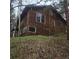 Wooden exterior of the cabin-style home is surrounded by a lush, mature forest at 10314 Red Fern Trl, Conifer, CO 80433