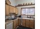 Kitchen with light wood cabinets, stainless sink and window with a forest view at 10314 Red Fern Trl, Conifer, CO 80433