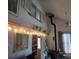 Cozy living room featuring a wood burning stove, exposed beam, and decorative string lights at 10314 Red Fern Trl, Conifer, CO 80433