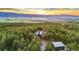 Aerial view of home surrounded by lush forest, showcasing its scenic location and mountain views at 5090 S Perry Park, Sedalia, CO 80135
