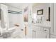 Clean bathroom featuring an updated vanity with a white countertop, tiled shower and a soaking tub at 5090 S Perry Park, Sedalia, CO 80135