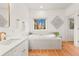 Serene bathroom features a soaking tub, marble countertops, and natural light at 5090 S Perry Park, Sedalia, CO 80135