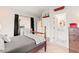 Comfortable bedroom featuring a wood frame bed and doorway to bathroom and closet at 5090 S Perry Park, Sedalia, CO 80135