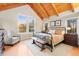 Comfortable bedroom featuring wood beam ceilings, lots of windows, and stylish decor at 5090 S Perry Park, Sedalia, CO 80135