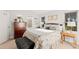Bright bedroom with a queen bed, dark dresser, and windows showing the outdoor scenery at 5090 S Perry Park, Sedalia, CO 80135