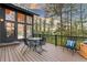 A spacious deck with dining area and seating, surrounded by tall trees at 5090 S Perry Park, Sedalia, CO 80135