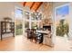 Stately dining room featuring a stone fireplace, wood beam ceiling, an antique hutch and wooded views at 5090 S Perry Park, Sedalia, CO 80135