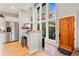 Bright entryway featuring large windows, wood door, and convenient desk area next to the stainless fridge at 5090 S Perry Park, Sedalia, CO 80135