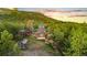 Beautiful exterior of home with a lush green lawn and greenhouse at 5090 S Perry Park, Sedalia, CO 80135