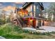 Lovely exterior view of home with stone accents, deck, and lush landscape at 5090 S Perry Park, Sedalia, CO 80135