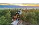 Stunning exterior view of a wood-sided home nestled amongst trees with a mountain view at 5090 S Perry Park, Sedalia, CO 80135