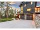 Wood and stone house exterior with lower level garage, upper deck, and landscaped yard at 5090 S Perry Park, Sedalia, CO 80135