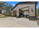 A large detached garage with multiple bays and a wide concrete driveway offers ample storage at 5090 S Perry Park, Sedalia, CO 80135