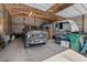 View of a large garage interior with a truck and trailer, offering ample storage and workspace at 5090 S Perry Park, Sedalia, CO 80135
