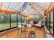 Interior of greenhouse featuring seating, table, and decor with natural light and scenic views at 5090 S Perry Park, Sedalia, CO 80135
