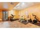 Basement gym with treadmill, weight rack, and stationary bike next to the walkout at 5090 S Perry Park, Sedalia, CO 80135