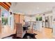 Kitchen with a breakfast bar, modern appliances, wood accents, and a sliding barn door feature at 5090 S Perry Park, Sedalia, CO 80135