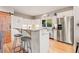 Kitchen featuring granite countertops, stainless steel appliances, white cabinets, and an eat-in island at 5090 S Perry Park, Sedalia, CO 80135