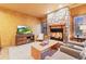 Comfortable living room with a stone fireplace and a large TV at 5090 S Perry Park, Sedalia, CO 80135
