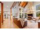 Spacious living room with vaulted ceilings, a stone fireplace, and ample natural light at 5090 S Perry Park, Sedalia, CO 80135