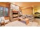 Cozy living room featuring a stone fireplace, two armchairs, and a coffee table at 5090 S Perry Park, Sedalia, CO 80135