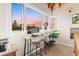 Bright office space with large windows offering stunning views and modern workspace with wooden desk and stools at 5090 S Perry Park, Sedalia, CO 80135