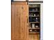 Well-organized pantry featuring custom shelving and a sliding barn door at 5090 S Perry Park, Sedalia, CO 80135