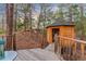 Charming wood playhouse accessible by a wooden deck, nestled amongst trees and foliage at 5090 S Perry Park, Sedalia, CO 80135