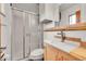Modern bathroom features a shower with sliding glass door and wood vanity at 1669 S Uvalda St, Aurora, CO 80012