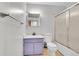 Cozy bathroom featuring a vanity, toilet, and shower with glass doors at 1669 S Uvalda St, Aurora, CO 80012