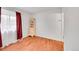 Simple room with wood floor and window with curtains and decorative furniture at 1669 S Uvalda St, Aurora, CO 80012