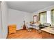 Bedroom featuring light floors, a window, and room for a desk at 1669 S Uvalda St, Aurora, CO 80012