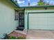 Close-up showcasing the home's front door, garage, and manicured front lawn at 1669 S Uvalda St, Aurora, CO 80012