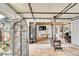 Open living area with tile floors, wood-burning stove, and lots of light from french doors at 1669 S Uvalda St, Aurora, CO 80012
