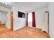 Comfortable living room with wood flooring and a wall-mounted TV at 1669 S Uvalda St, Aurora, CO 80012