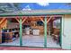 Outdoor kitchen with built-in grill, countertop, sink, wood ceiling, tv, and seating area at 1669 S Uvalda St, Aurora, CO 80012