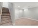 Finished basement with carpet, white door, and stairs with carpet at 335 N 11Th Ave, Brighton, CO 80601